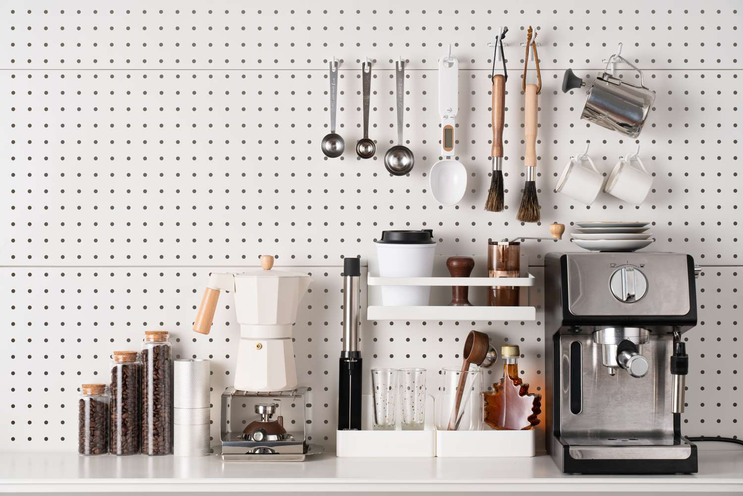 A white pegboard with a coffee machine