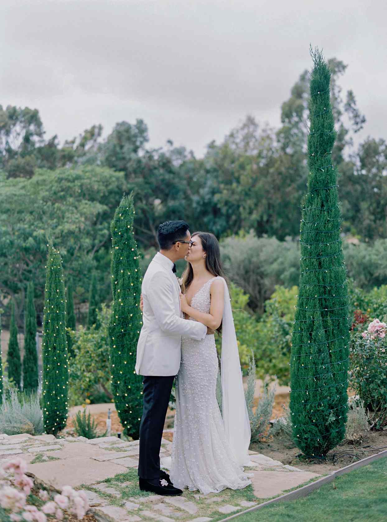 bride and groom kissing in garden