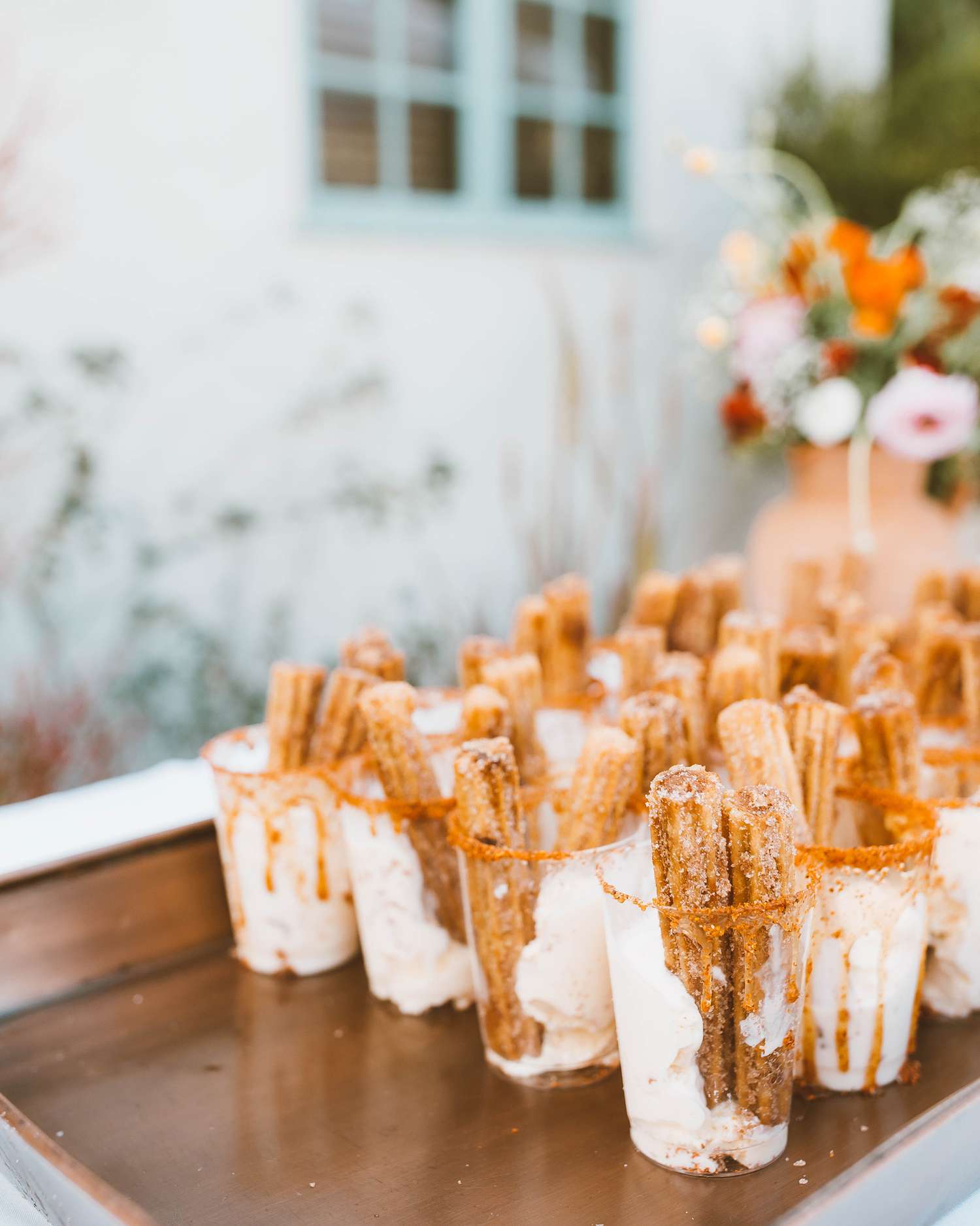 cups with churros and vanilla ice cream