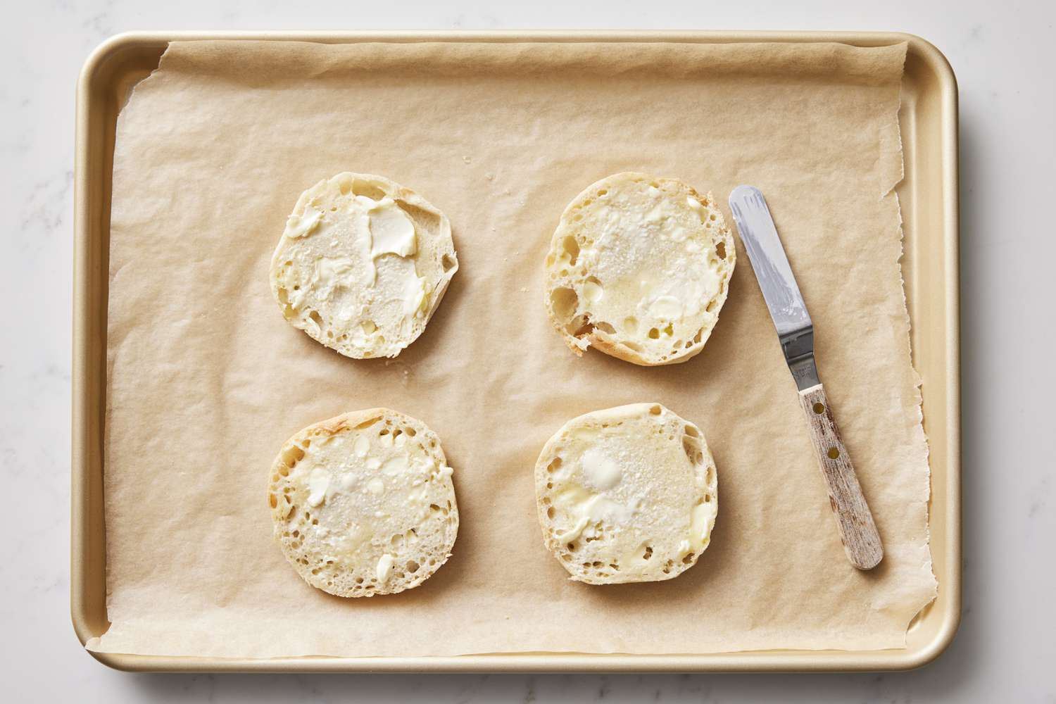 English muffins on baking sheet