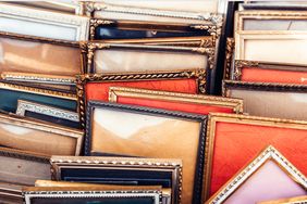 A variety of ornate vintage frames stacked closely together