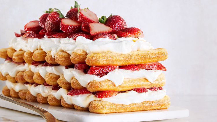 strawberries-and-cream stack cake topped with fresh strawberries