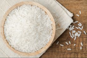 Rice in a wooden bowl on wooden table