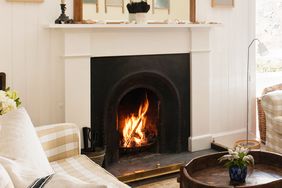 A cozy room with a lit fireplace surrounded by furniture and decor