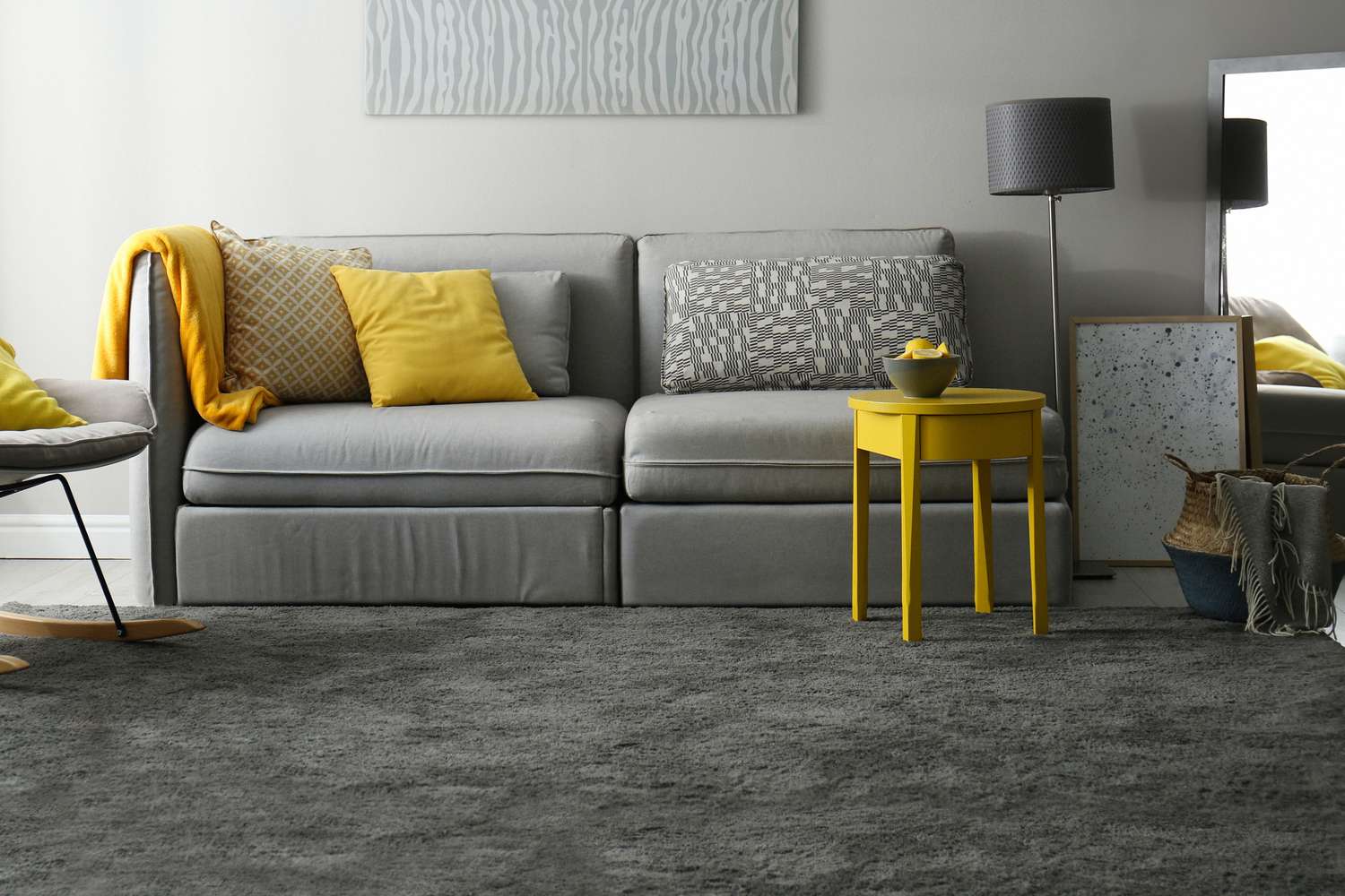 Living room with sofa in grey and yellow colors