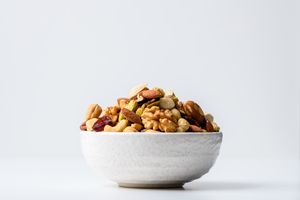 A bowl filled with assorted mixed nuts and dried fruits
