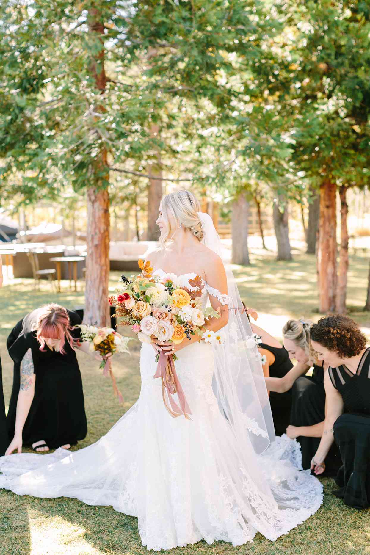 alexandra david wedding bride with maids adjusting dress