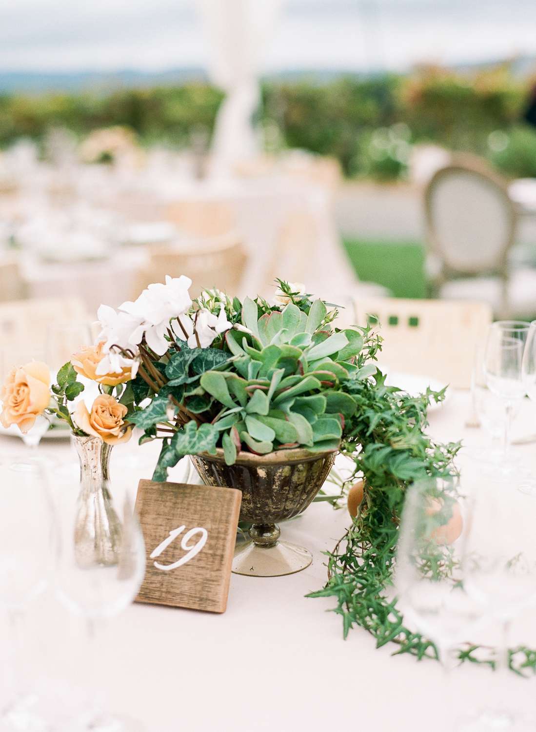 greenery plant reception table decor with golden lanterns and floral accents