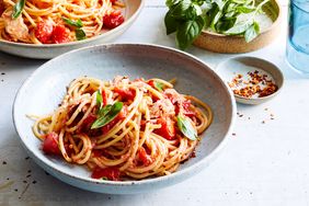spaghetti and no-cook tomato-tuna sauce topped with basil leaves