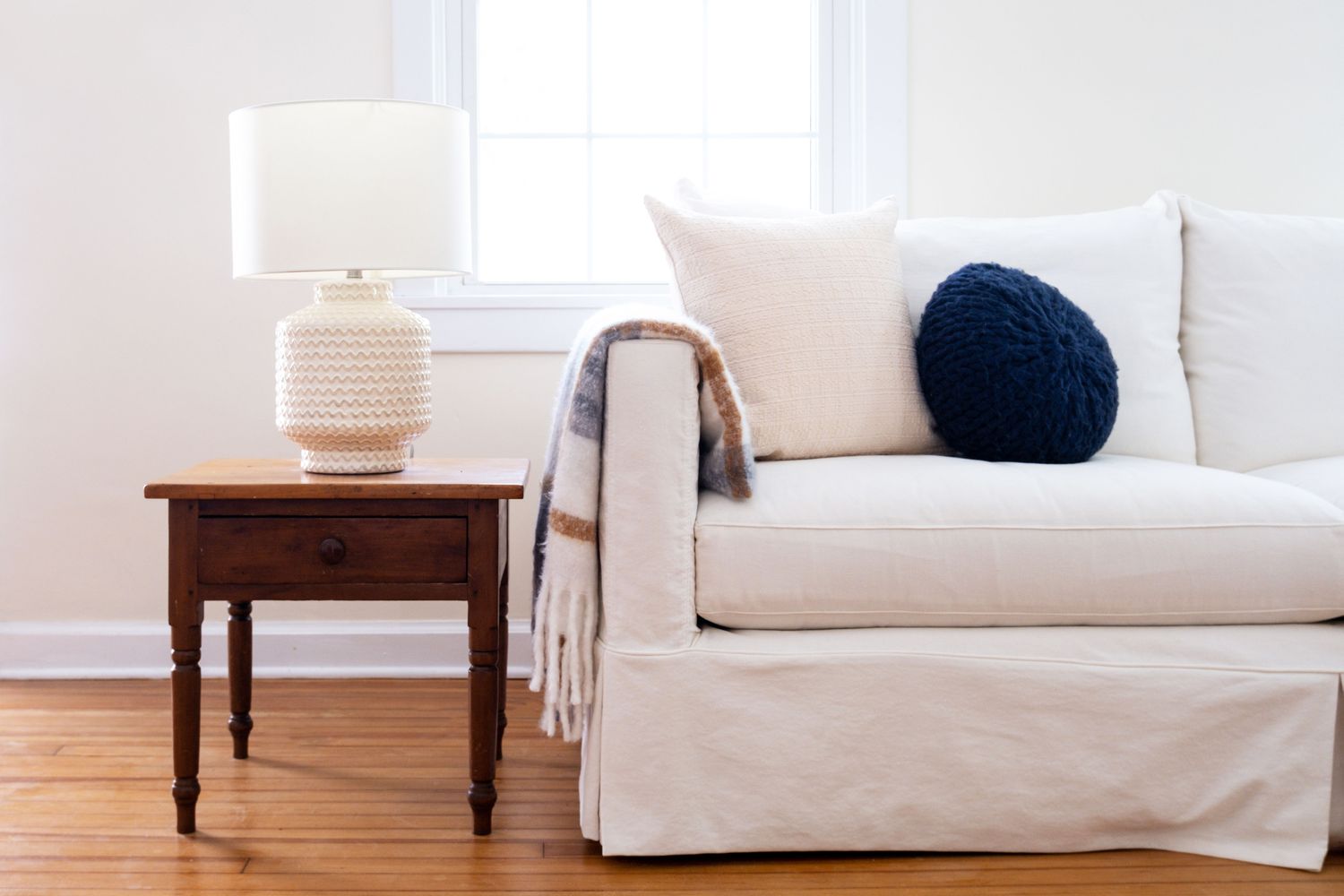 Living room with white couch and ceramic lamp