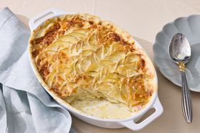 A casserole dish containing baked scalloped potatoes with golden crust