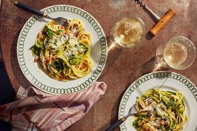 zucchini carbonara topped with fresh basil leaves