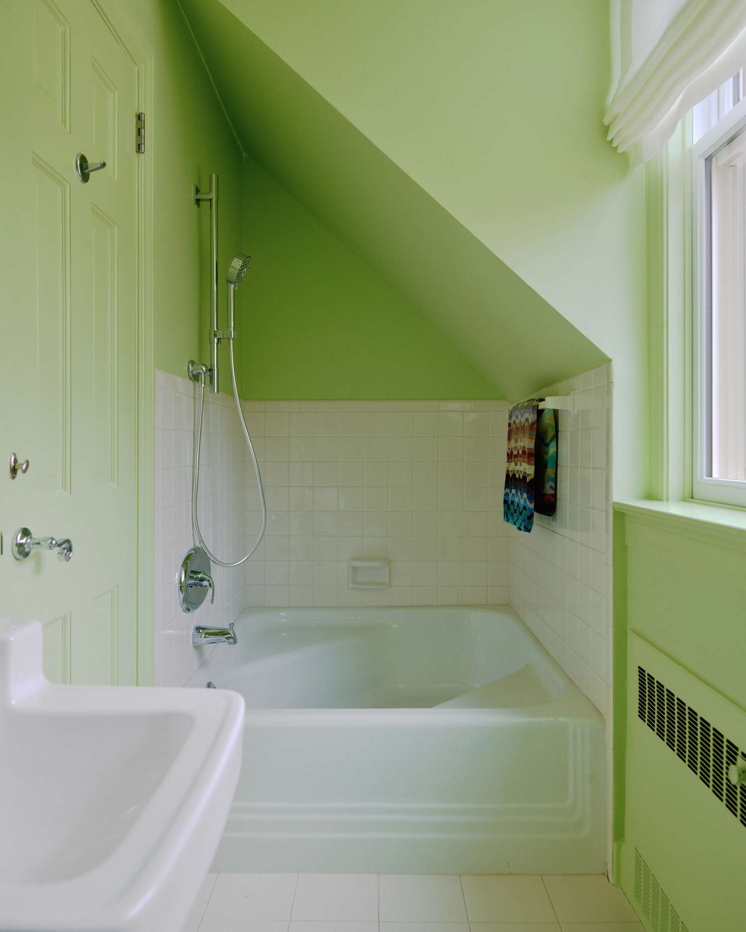 A small historic bathroom drenched in neon green
