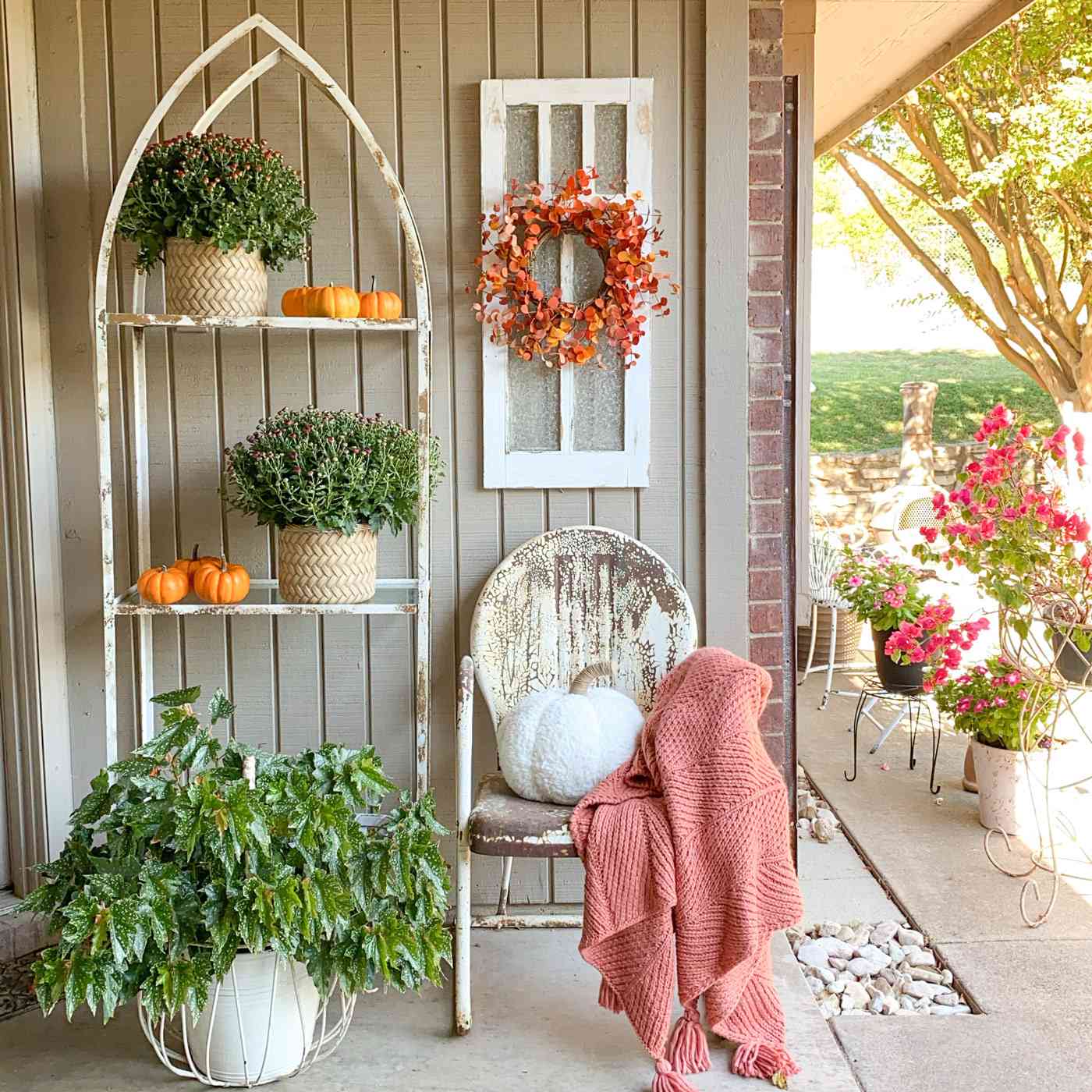 fall porch weathered shelves and chair pumpkins and mums