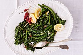sprouting broccoli with peperoncini served with lemon wedges