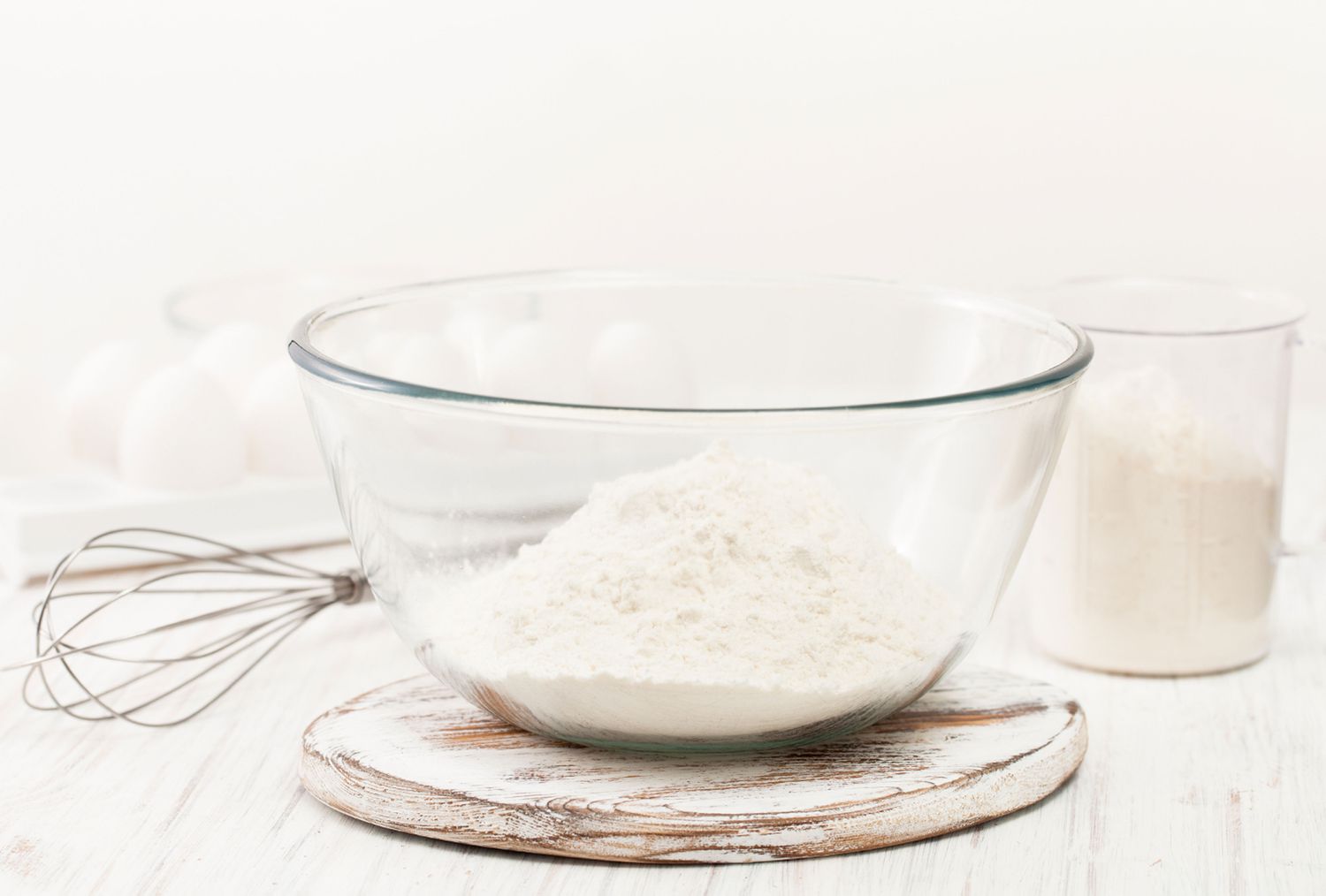Flour in glass bowl with whisk