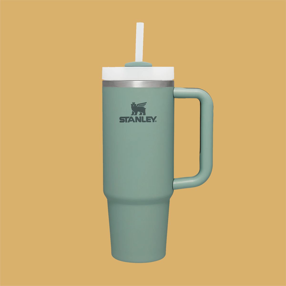 Stanley travel tumbler in green on a yellow background