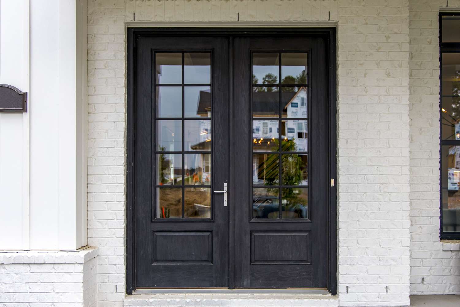 A set of double French doors with glass panels, leading to an interior or exterior space