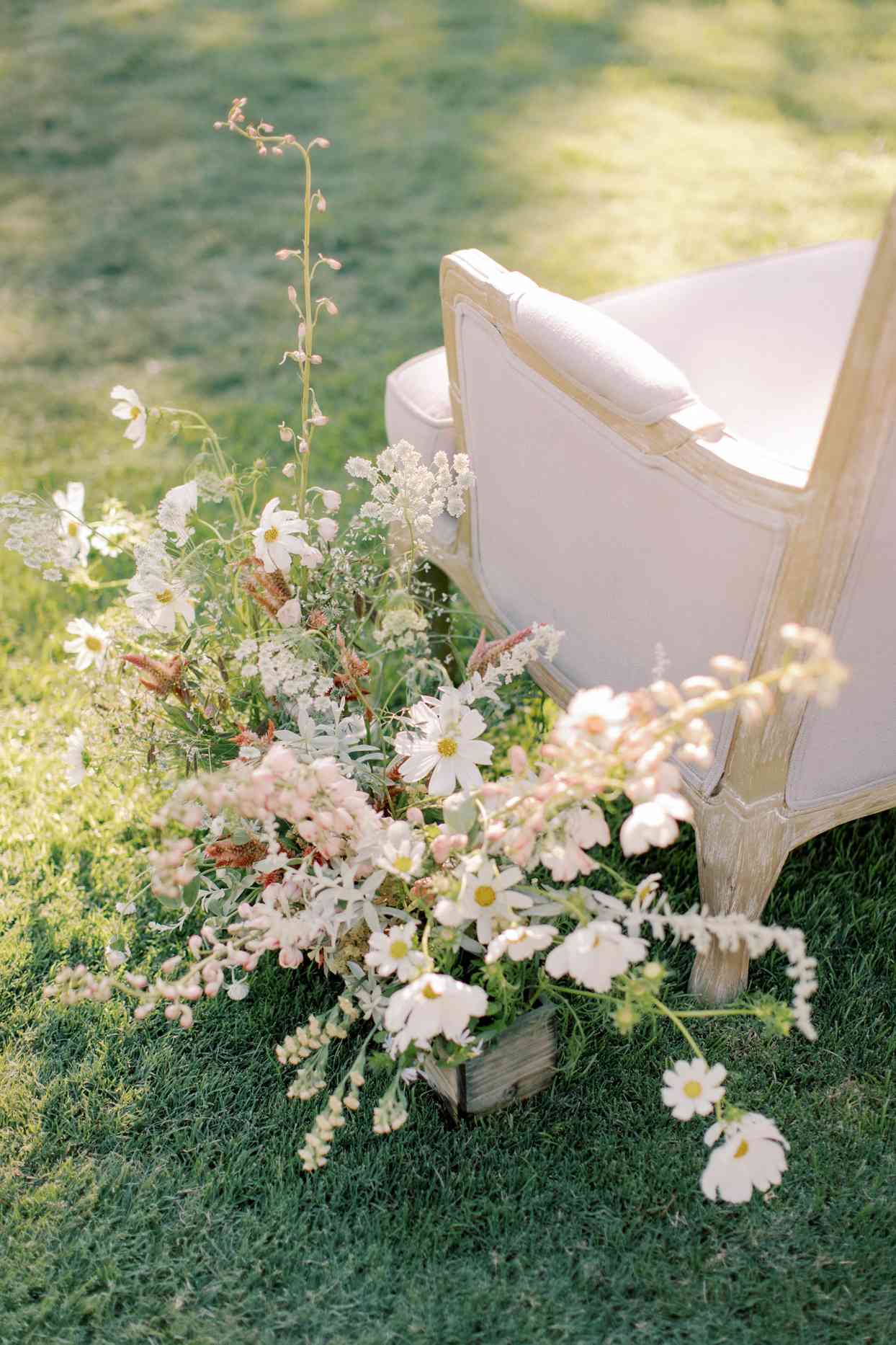 wedding ceremony loveseats for parents with floral decor