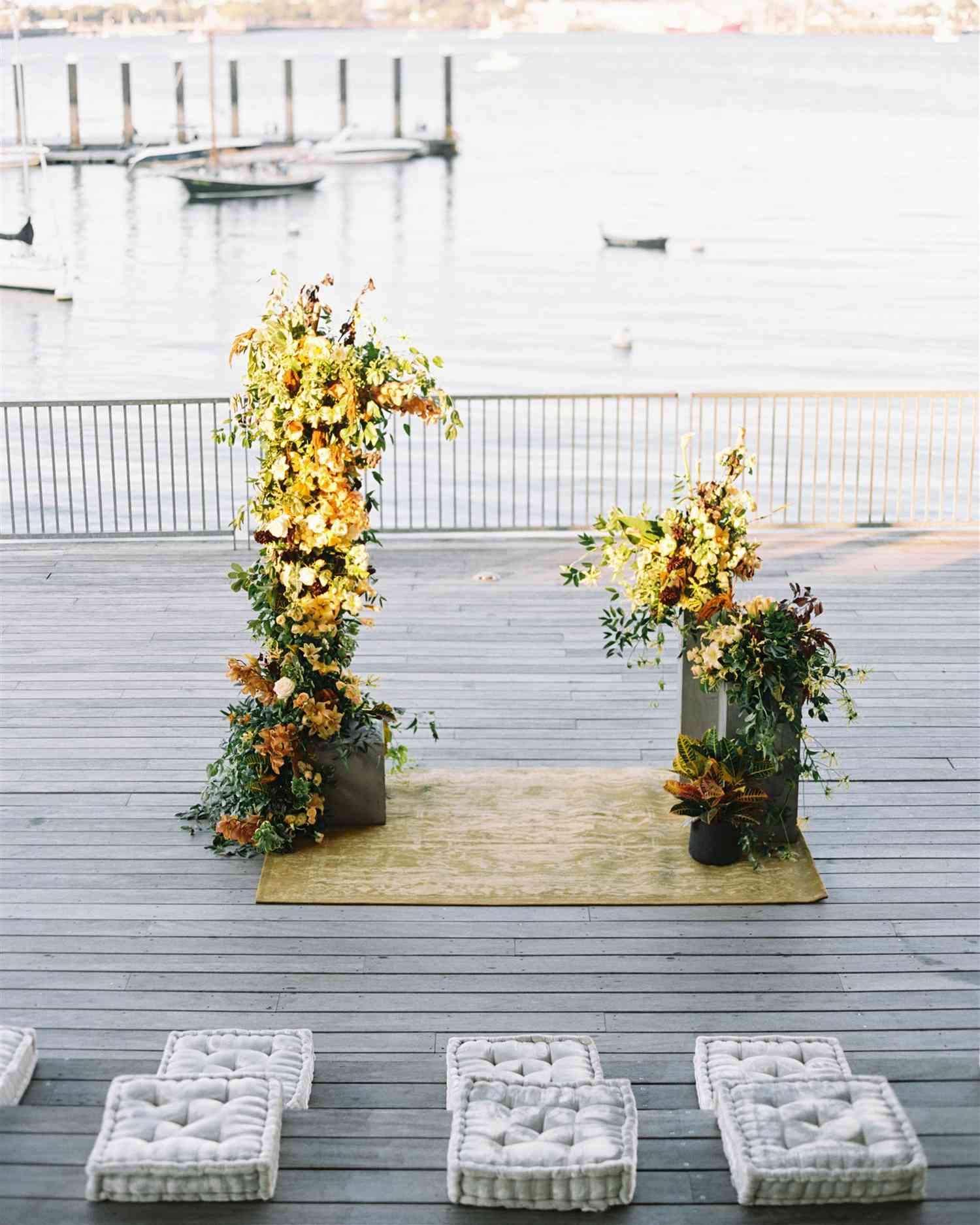 altar on deck with fall flower arrangements water and dock in background