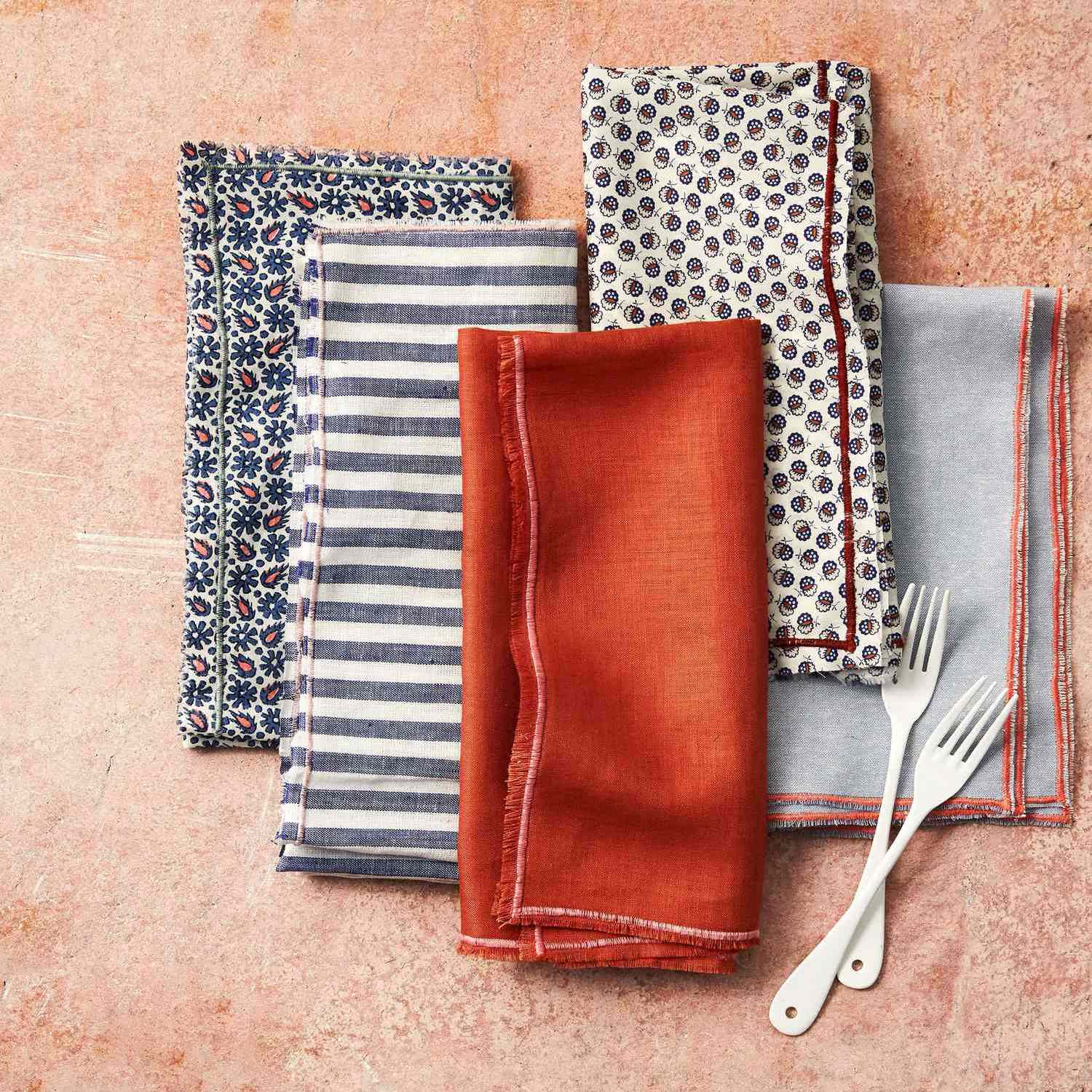 edged cloth napkins orange blue stripes folded