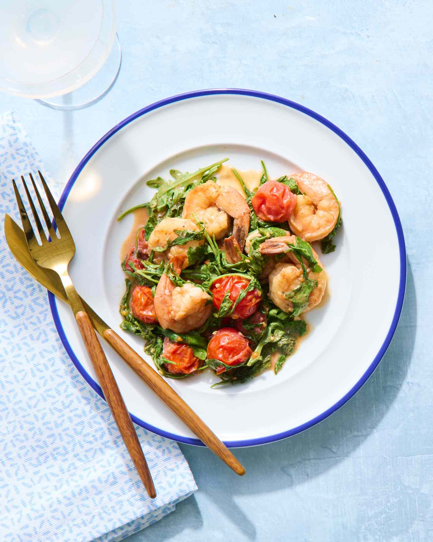 Sauteed shrimp plate with arugula and cherry tomatoes