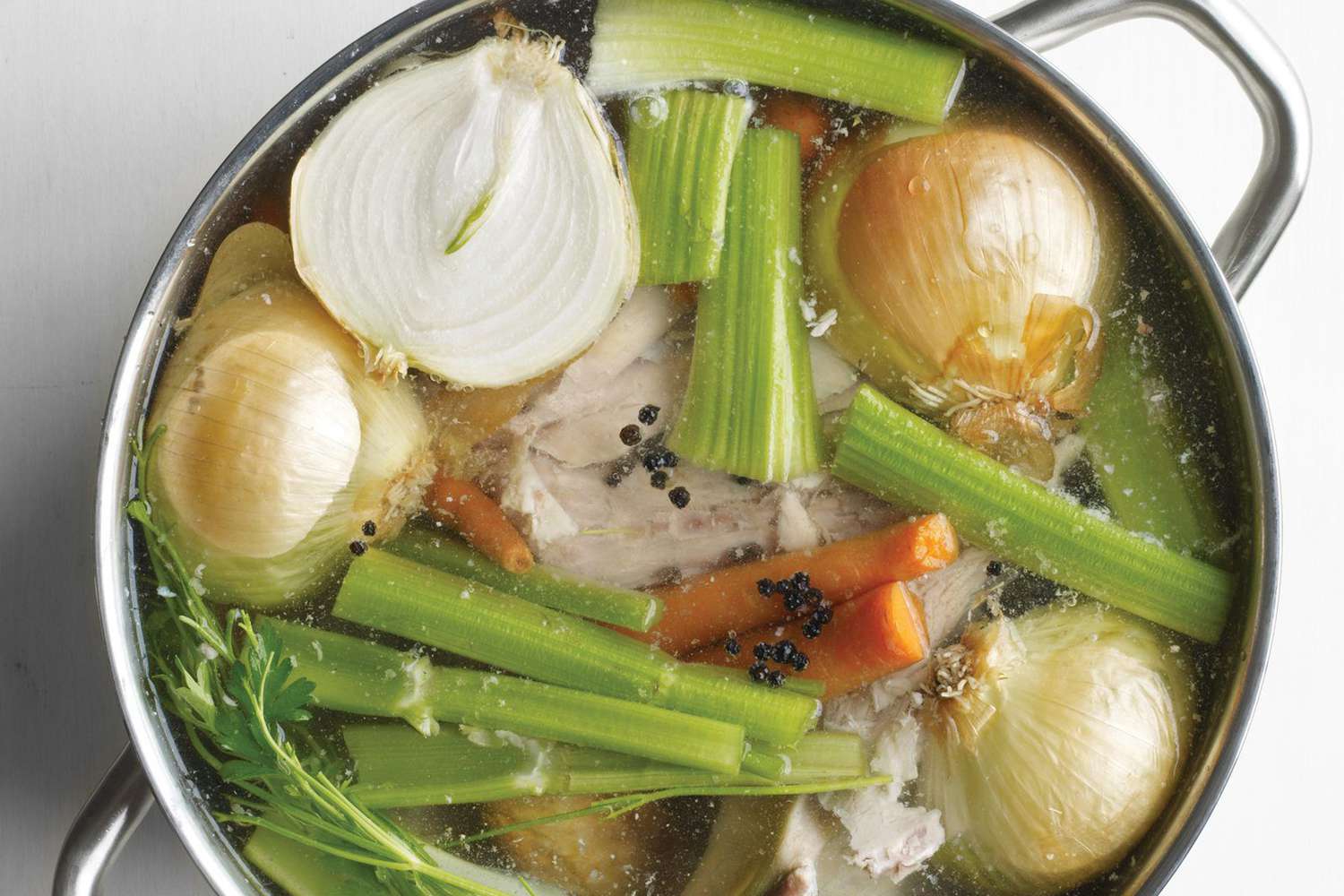 close up of turkey stock and veggies in a pot