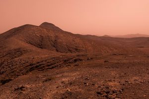 Barren and rocky landscape with hills in the background