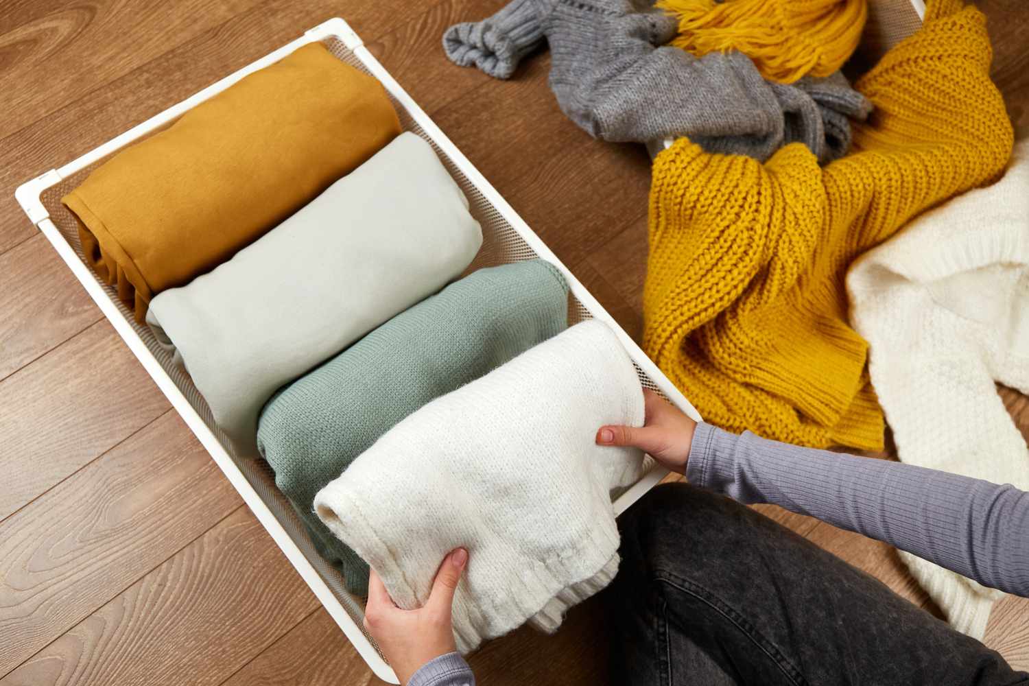 folding scarves into storage bin