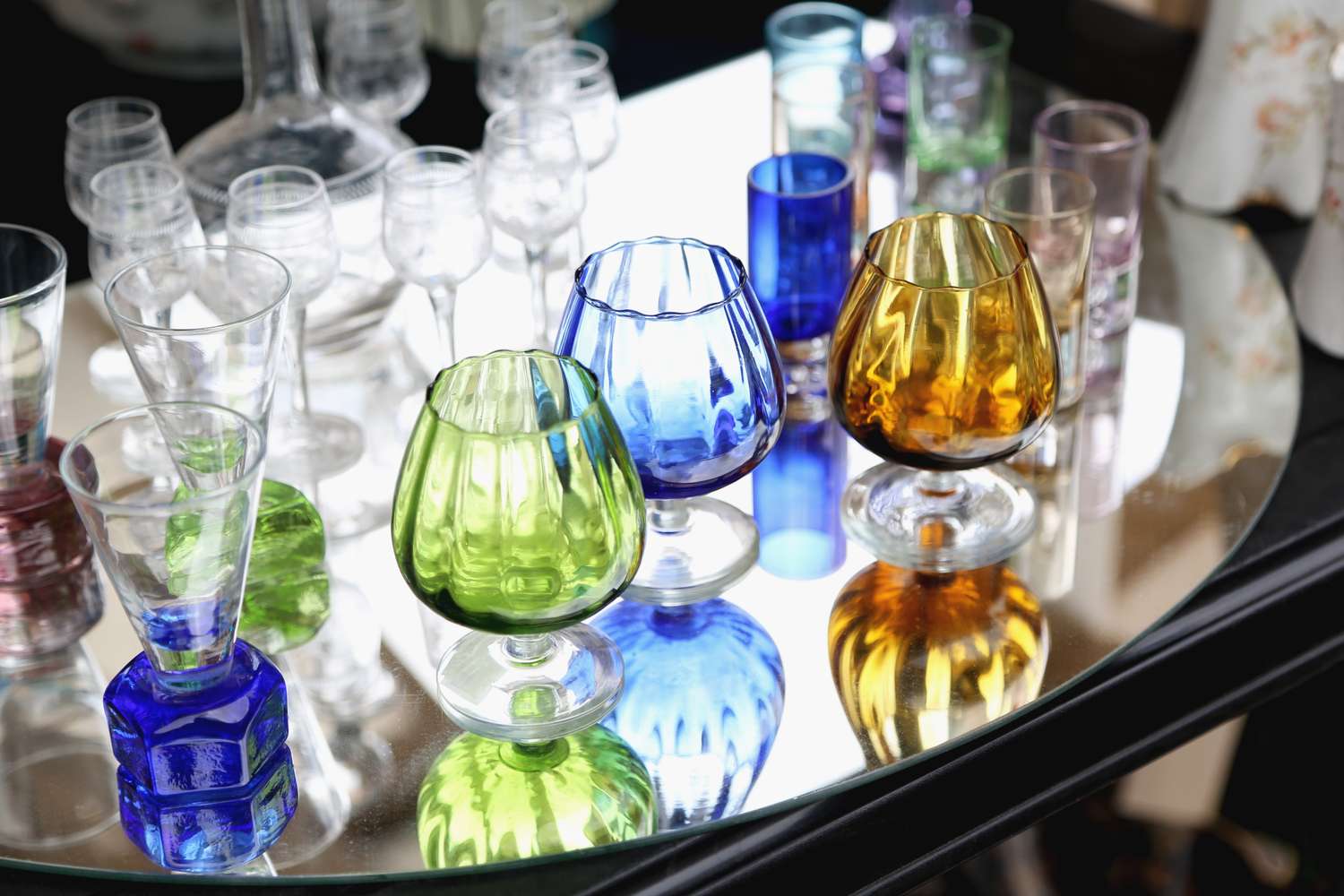 Array of colored glassware on a reflective surface