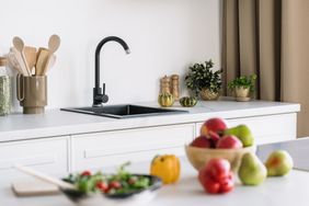 Fruit on counter near kitchen sink 