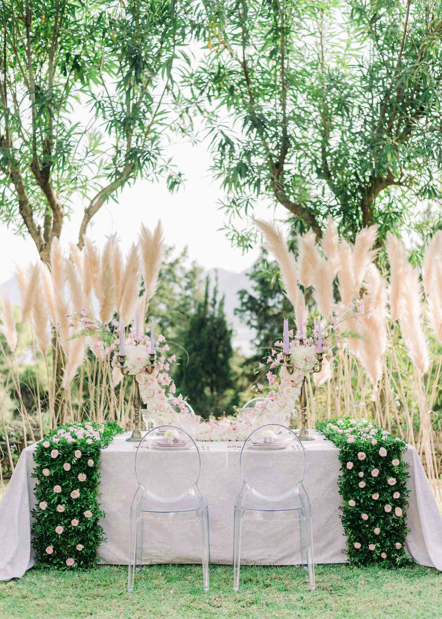 sweetheart table outdoor grass backdrop symmetrical display
