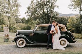 bride and groom standing next to 1936 Model A Ford vintage car