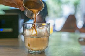 barista making an iced espresso drink