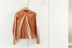 Leather jacket hanging from wardrobe