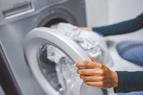 loading laundry into washing machine