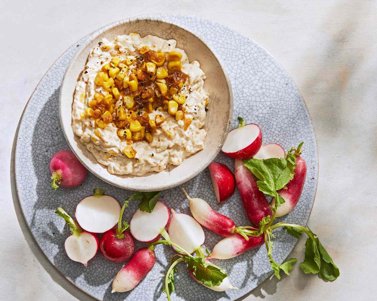 creamy corn-and-onion dip served with radishes