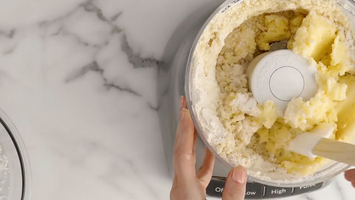 adding flour to dough for coconut cookies