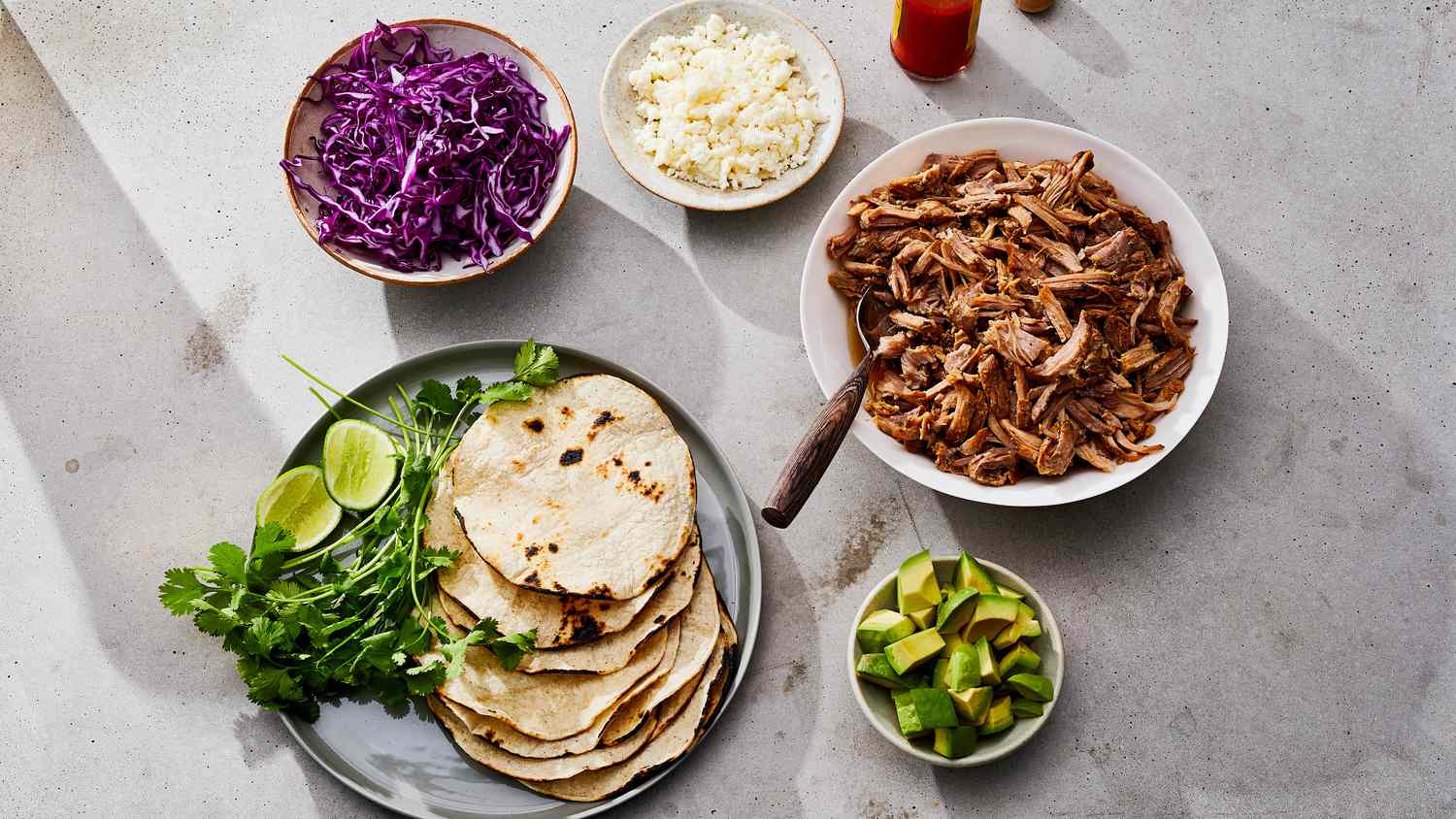 instant pot carnitas with tortillas, avocado, and cabbage