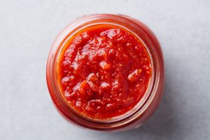A jar filled with tomato sauce viewed from above