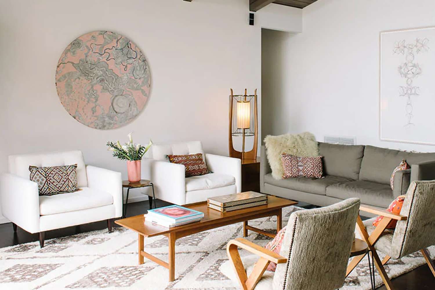 neutral living room with chairs and a tan sofa