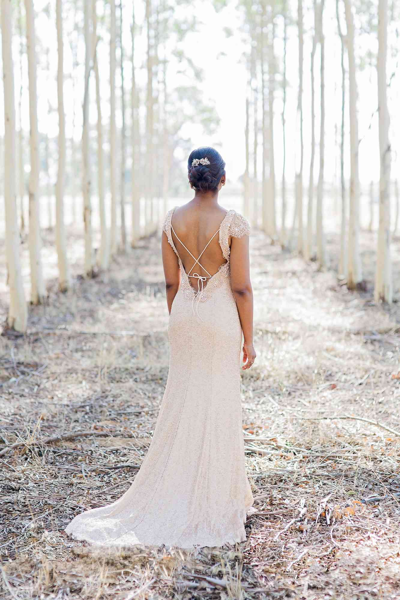 bride with open-back dress and chic bun