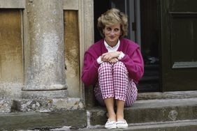 Princess Diana sitting on the outside steps of her home