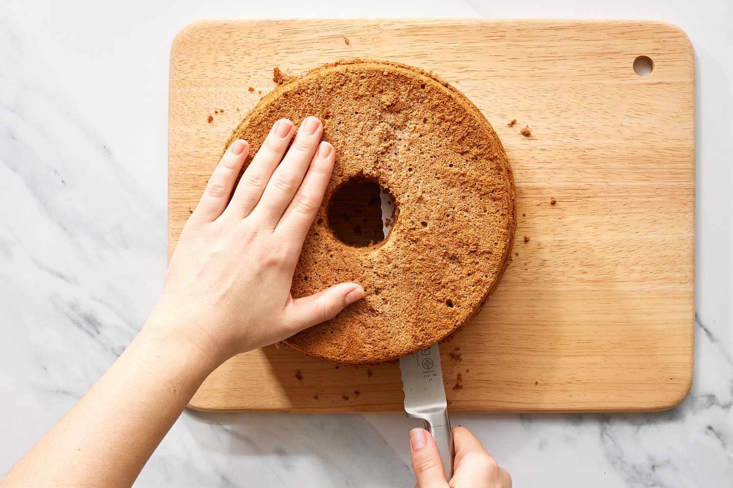 Cutting chocolate cake on cutting board