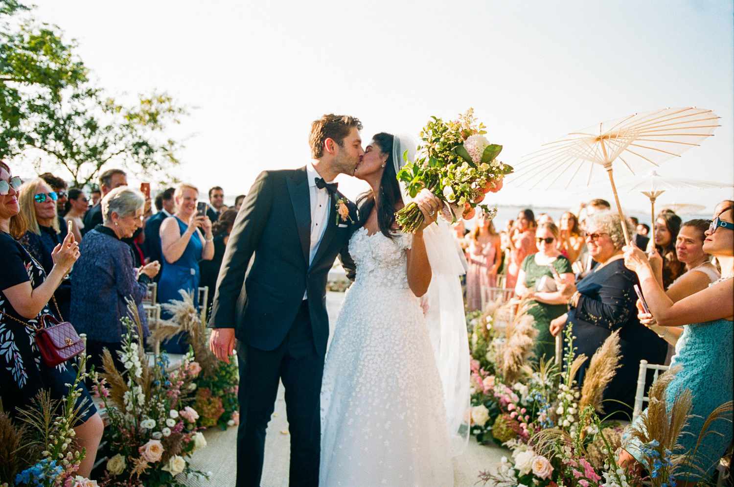 bride and groom kissing during wedding ceremony