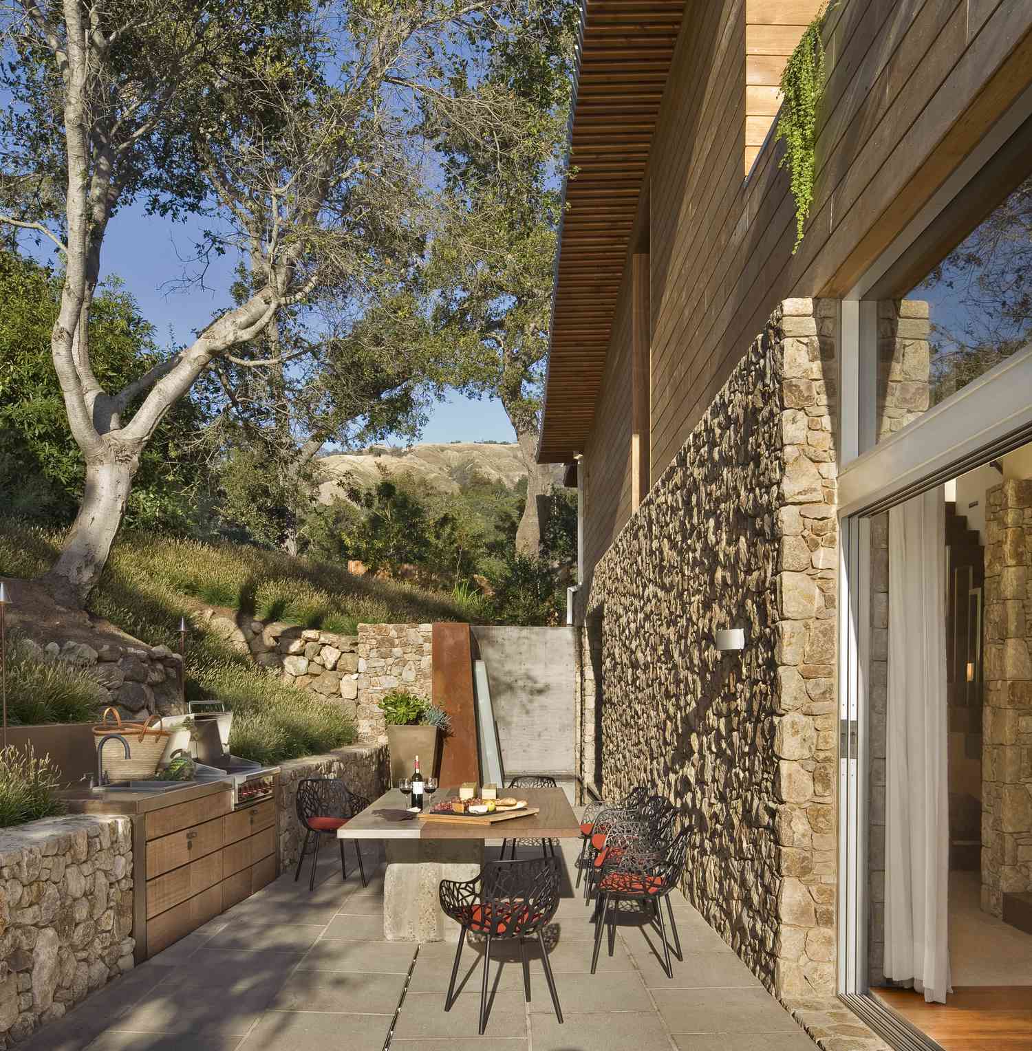 an outdoor patio cut into a sloping yard