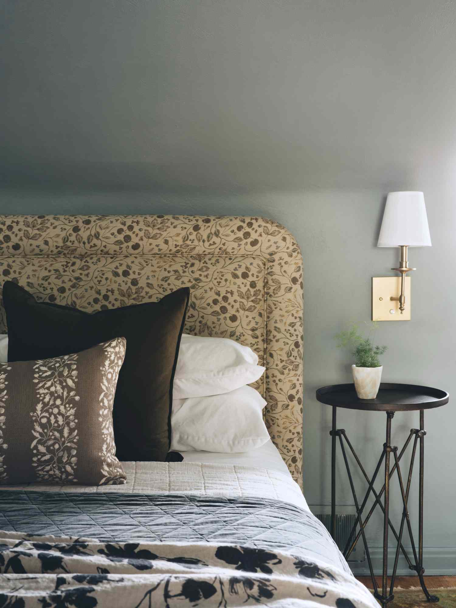a bed with floral headboard