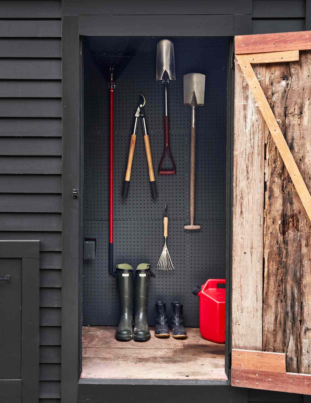 tools hanging and boots inside shed