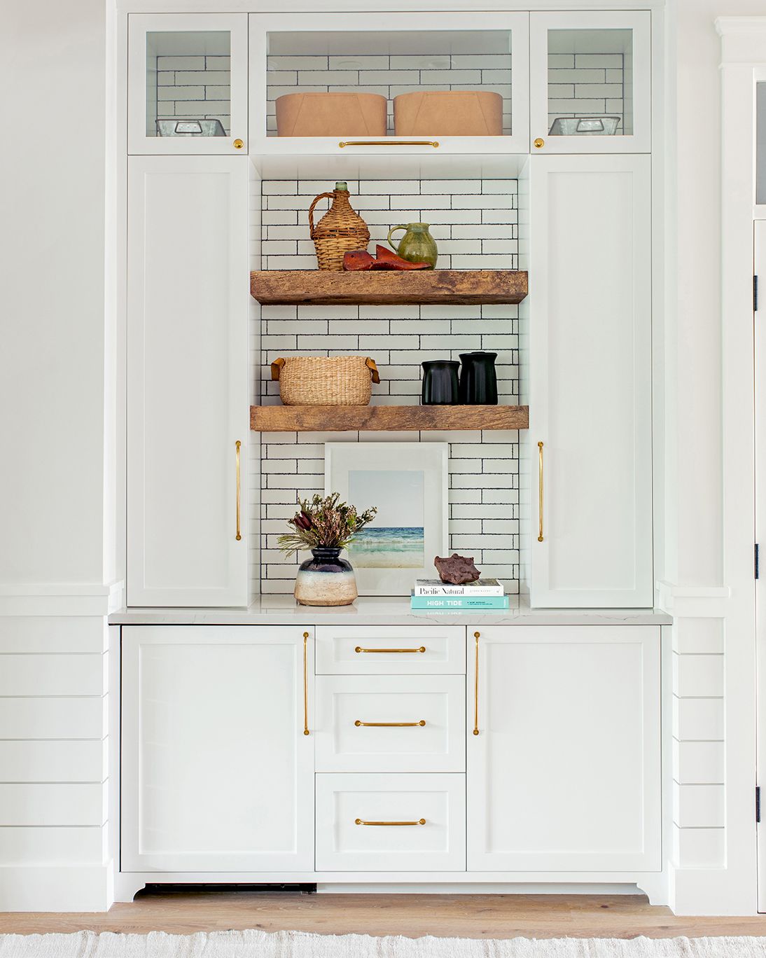 white butler's pantry with cabinets and tile backsplash