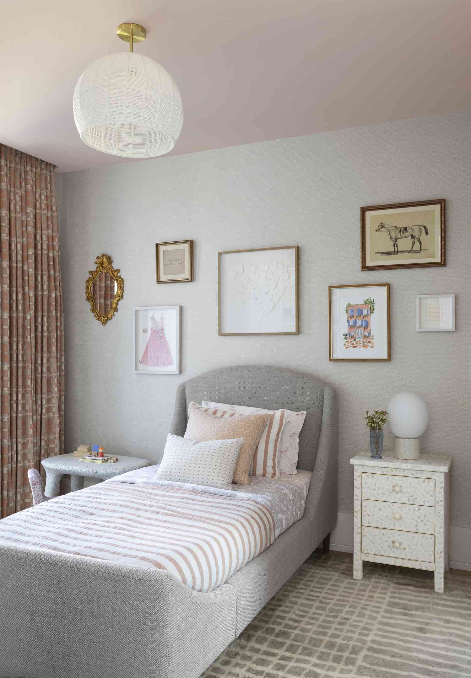 a girls bedroom with a pink ceiling and bedding, twin bed, and a gray gridded rug